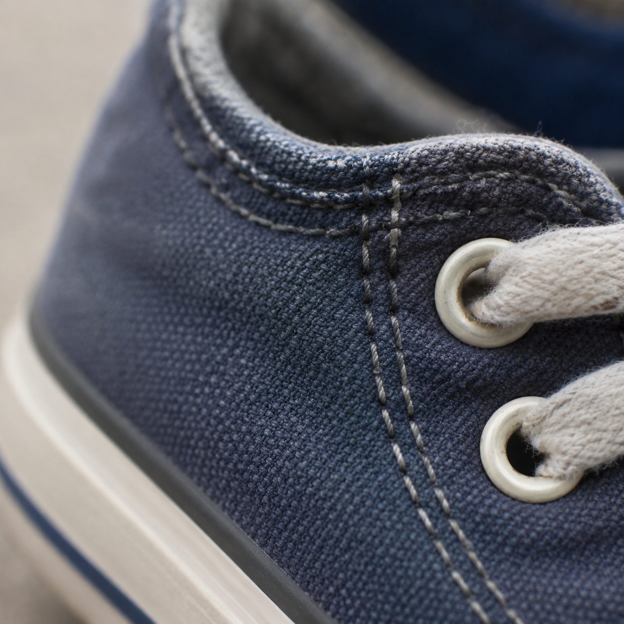 Macro of neat stitching and eyelets on a children's shoe upper